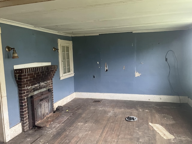 722 Farmington Rd, Strong, ME 04983 - unfurnished living room with crown molding, a brick fireplace, hardwood / wood-style flooring, and baseboards