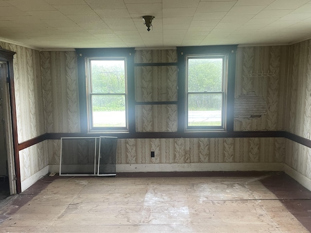 722 Farmington Rd, Strong, ME 04983 - empty room with plenty of natural light, baseboards, light wood-type flooring, and wallpapered walls