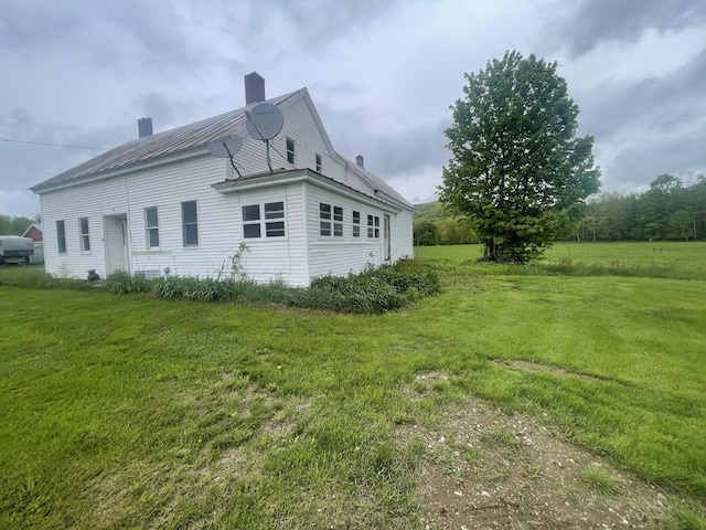 722 Farmington Rd, Strong, ME 04983 - view of property exterior with a chimney, a lawn, and metal roof