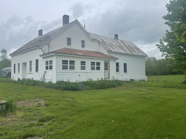 722 Farmington Rd, Strong, ME 04983 - rear view of property with a lawn, a chimney, and metal roof