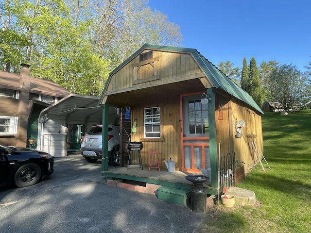 2130 Summerhaven Rd, Sidney, ME 04330 - view of front facade with a detached carport, a front lawn, an outbuilding, driveway, and metal roof