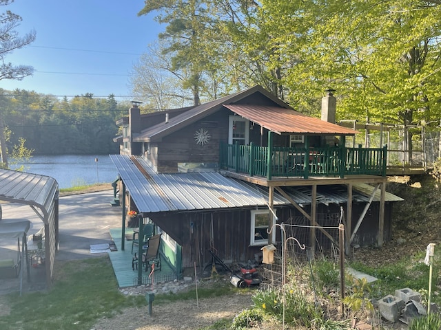 2130 Summerhaven Rd, Sidney, ME 04330 - rear view of property with a deck, metal roof, and a chimney