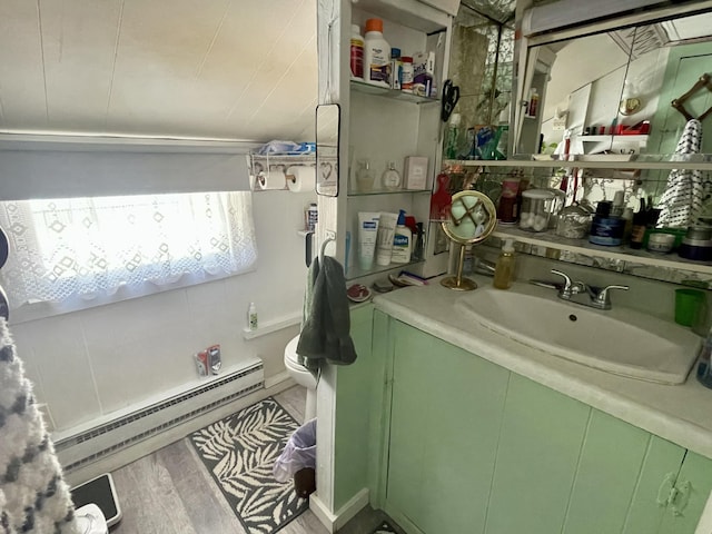 2130 Summerhaven Rd, Sidney, ME 04330 - bathroom featuring vanity, a baseboard heating unit, and wood finished floors