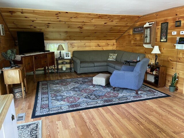 2130 Summerhaven Rd, Sidney, ME 04330 - living room with wood finished floors, wooden walls, and vaulted ceiling