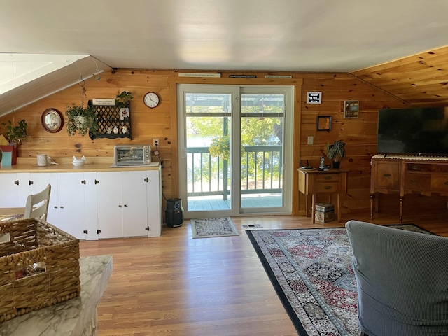 2130 Summerhaven Rd, Sidney, ME 04330 - living area featuring wooden walls, lofted ceiling, and light wood finished floors