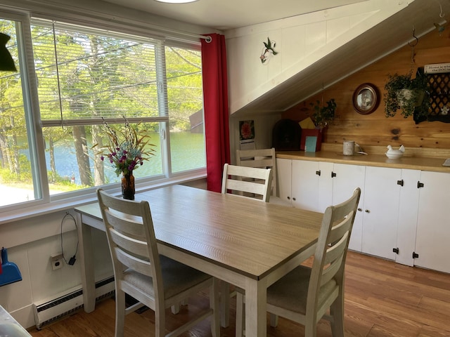 2130 Summerhaven Rd, Sidney, ME 04330 - dining room with a baseboard radiator, light wood-style flooring, and vaulted ceiling