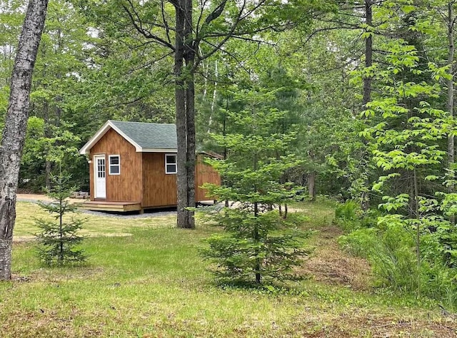 172 Blanchard Rd, Monson, ME 04464 - view of shed featuring a wooded view