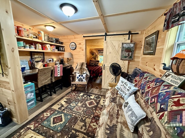 172 Blanchard Rd, Monson, ME 04464 - living area featuring wooden walls, a barn door, and wood finished floors