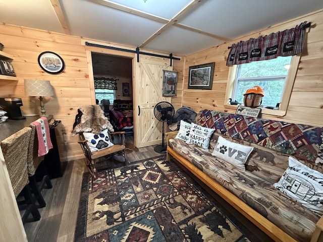 172 Blanchard Rd, Monson, ME 04464 - living room with a barn door, wooden walls, and wood finished floors
