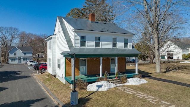 224 N St Unit 101-102, Saco, ME 04072 - view of front facade featuring covered porch, a chimney, and a front lawn