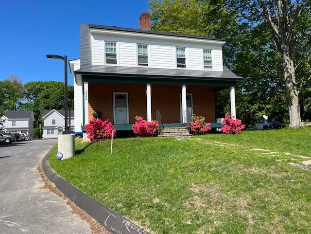 224 N St Unit 101-102, Saco, ME 04072 - view of front of house with a porch, a chimney, and a front lawn