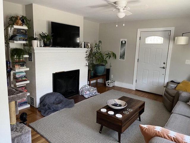 224 N St Unit 101-102, Saco, ME 04072 - living room featuring a ceiling fan, wood finished floors, a brick fireplace, and baseboards