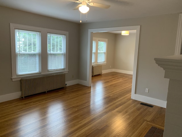 224 N St Unit 101-102, Saco, ME 04072 - unfurnished room featuring radiator, a ceiling fan, and baseboards