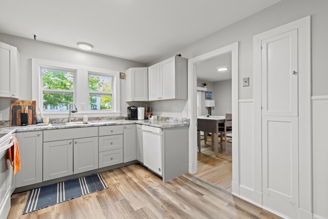 224 N St Unit 101-102, Saco, ME 04072 - kitchen featuring dishwasher, a sink, light wood-style flooring, and white cabinetry
