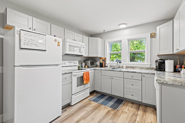 224 N St Unit 101-102, Saco, ME 04072 - kitchen featuring white appliances, light wood-style flooring, a sink, and light stone counters