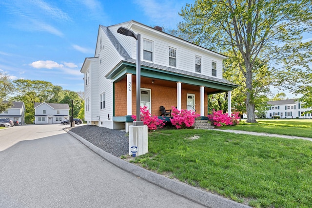 224 N St Unit 101-102, Saco, ME 04072 - view of front of home featuring a porch, a front yard, and asphalt driveway
