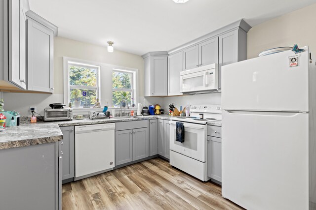 224 N St Unit 101-102, Saco, ME 04072 - kitchen featuring white appliances, gray cabinets, a sink, and light wood-style flooring
