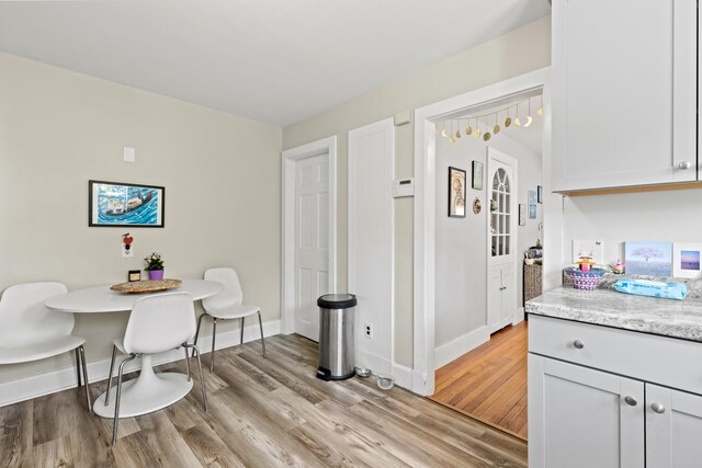224 N St Unit 101-102, Saco, ME 04072 - dining area with light wood-type flooring and baseboards