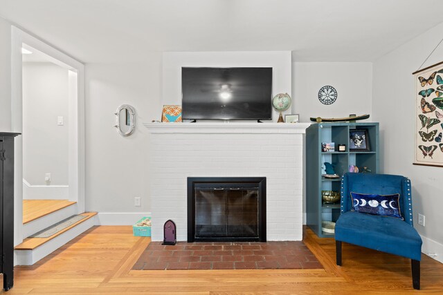 224 N St Unit 101-102, Saco, ME 04072 - living area featuring a brick fireplace, wood finished floors, baseboards, and stairs