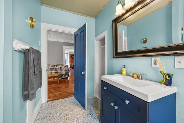 43 Whales Back Rd, Sullivan, ME 04664 - bathroom with crown molding, baseboards, and vanity