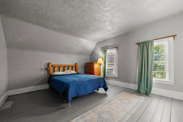 43 Whales Back Rd, Sullivan, ME 04664 - bedroom featuring wood-type flooring, a textured ceiling, baseboards, and lofted ceiling