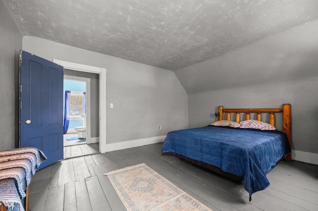 43 Whales Back Rd, Sullivan, ME 04664 - bedroom featuring hardwood / wood-style floors, a textured ceiling, baseboards, and lofted ceiling