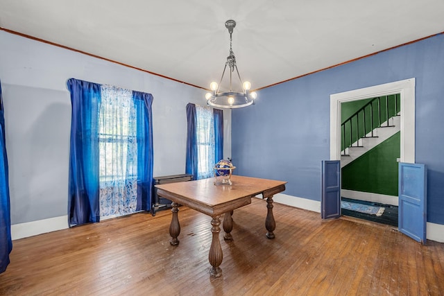 43 Whales Back Rd, Sullivan, ME 04664 - dining space with a chandelier, ornamental molding, hardwood / wood-style floors, stairway, and baseboards