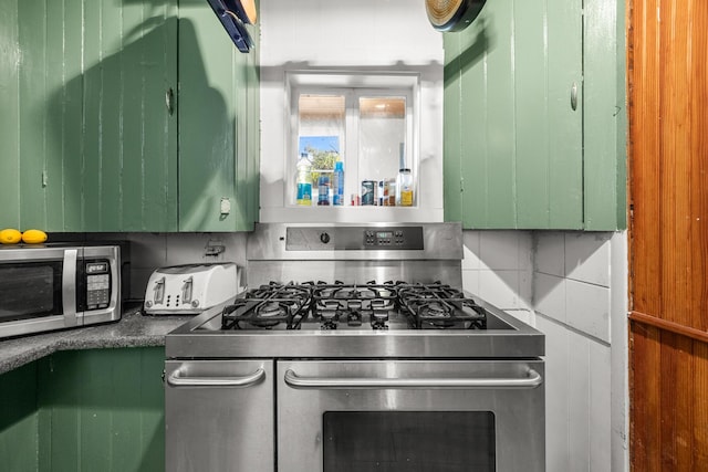 43 Whales Back Rd, Sullivan, ME 04664 - kitchen with stainless steel appliances, green cabinetry, and tasteful backsplash
