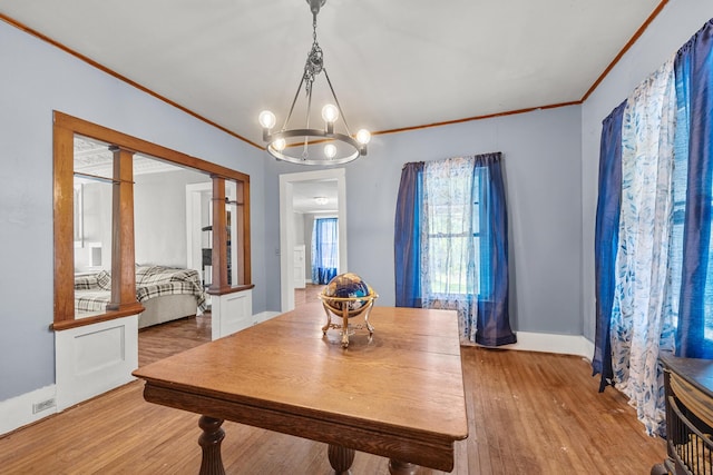 43 Whales Back Rd, Sullivan, ME 04664 - dining room featuring crown molding, wood finished floors, a chandelier, and baseboards