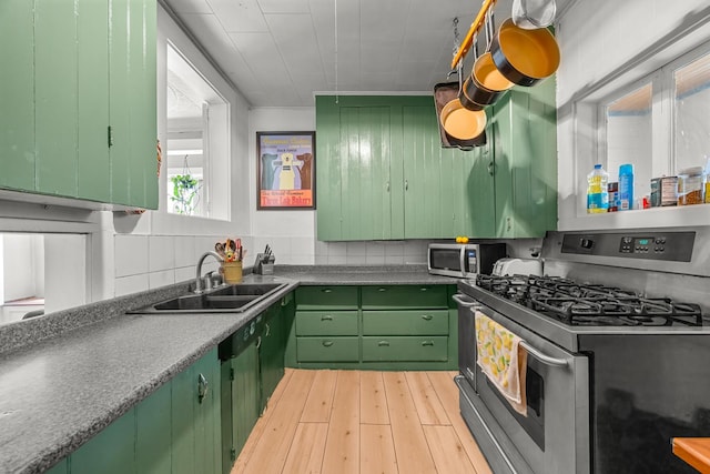 43 Whales Back Rd, Sullivan, ME 04664 - kitchen featuring appliances with stainless steel finishes, a sink, green cabinets, and light wood-style flooring