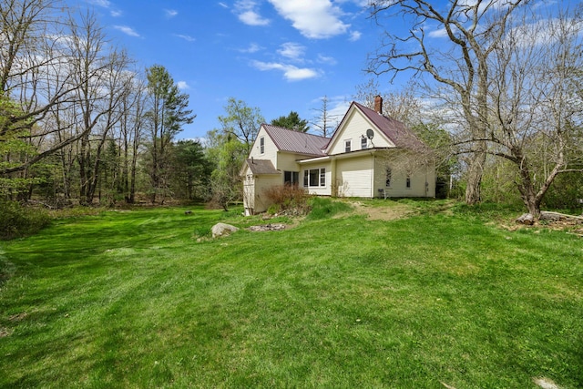 43 Whales Back Rd, Sullivan, ME 04664 - view of property exterior featuring a chimney, a lawn, and metal roof