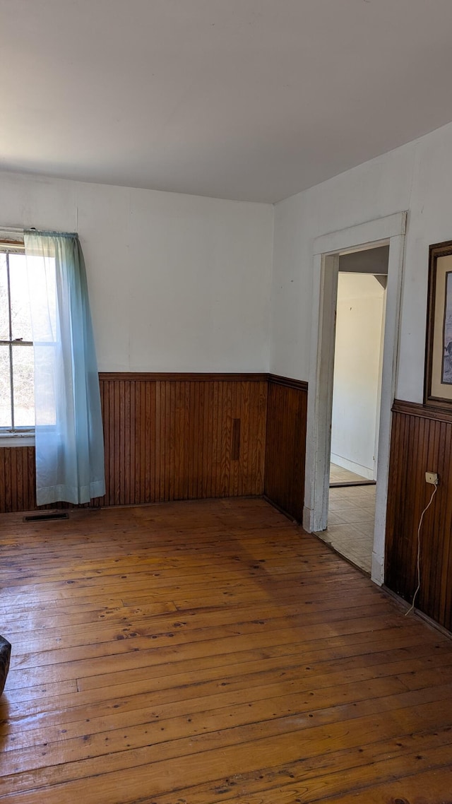 19 Lubec Rd, Whiting, ME 04691 - empty room featuring a wainscoted wall, hardwood / wood-style flooring, and wood walls