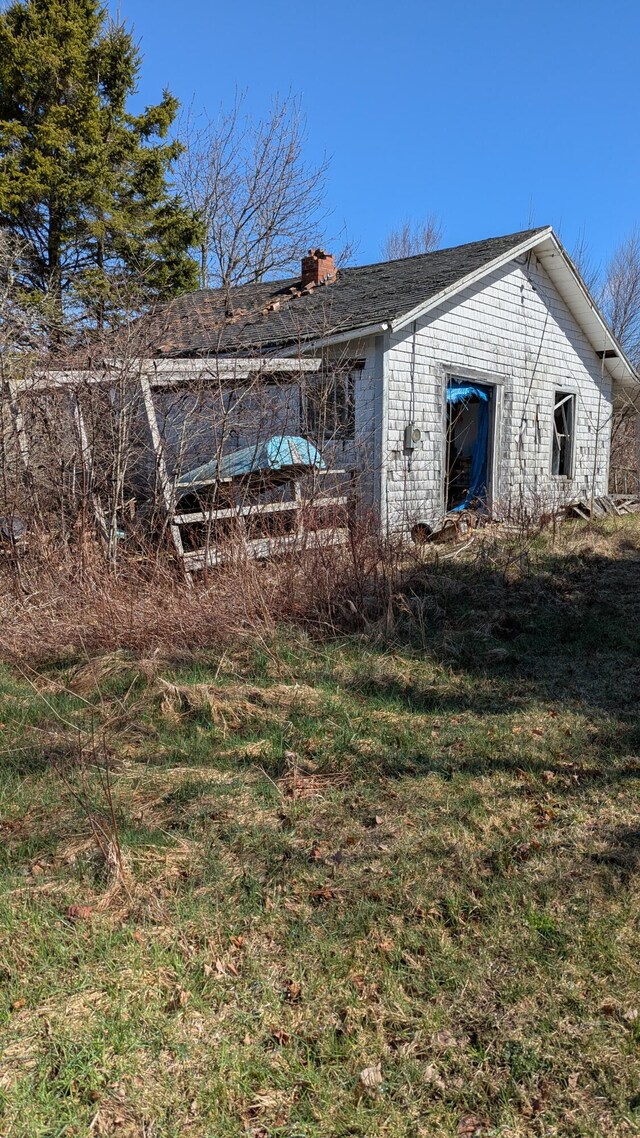 19 Lubec Rd, Whiting, ME 04691 - rear view of property with a chimney and a yard