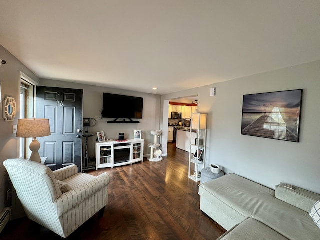 16 Caron Dr, Howland, ME 04448 - living room featuring dark wood-style flooring, a baseboard heating unit, and recessed lighting
