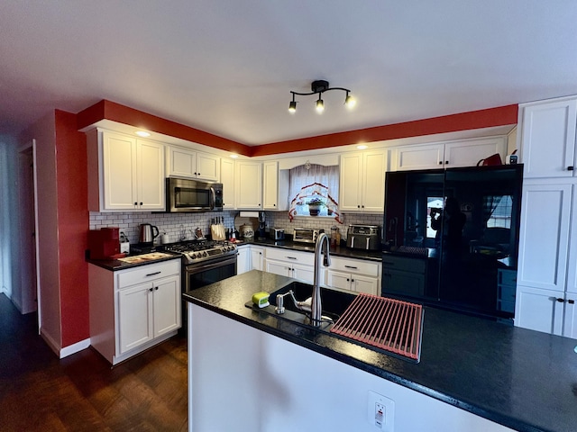 16 Caron Dr, Howland, ME 04448 - kitchen with stainless steel appliances, dark countertops, dark wood finished floors, white cabinetry, and tasteful backsplash