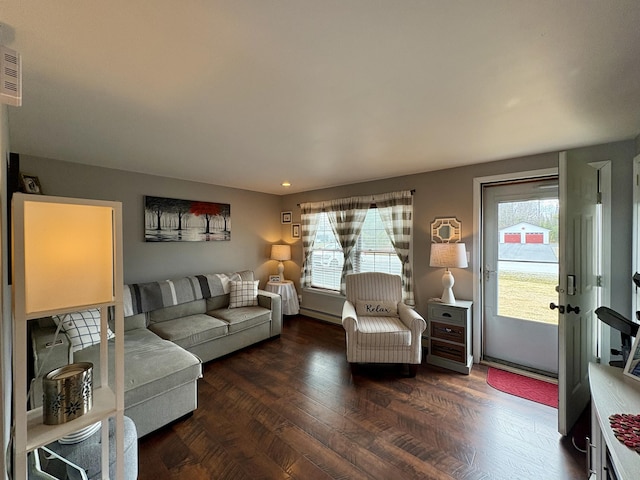 16 Caron Dr, Howland, ME 04448 - living room with plenty of natural light, baseboard heating, and dark wood-style flooring