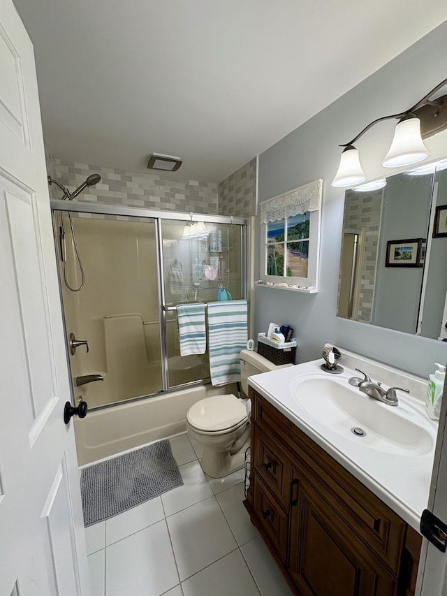 16 Caron Dr, Howland, ME 04448 - full bath with tile patterned flooring, vanity, toilet, and combined bath / shower with glass door