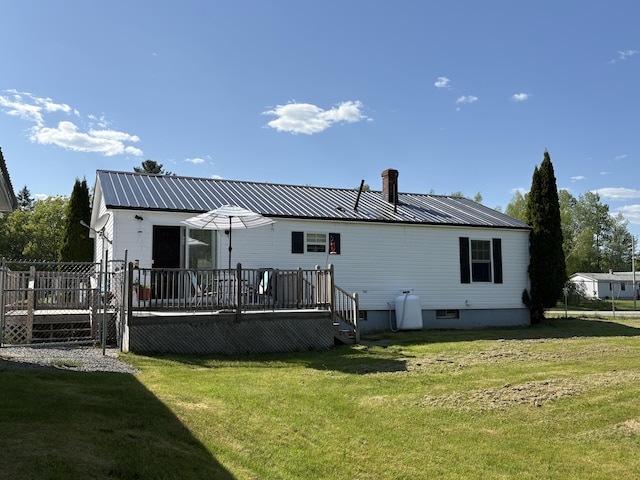 16 Caron Dr, Howland, ME 04448 - rear view of house featuring a wooden deck, a lawn, and metal roof