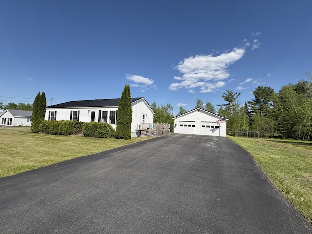 16 Caron Dr, Howland, ME 04448 - view of front facade with a garage and an outdoor structure