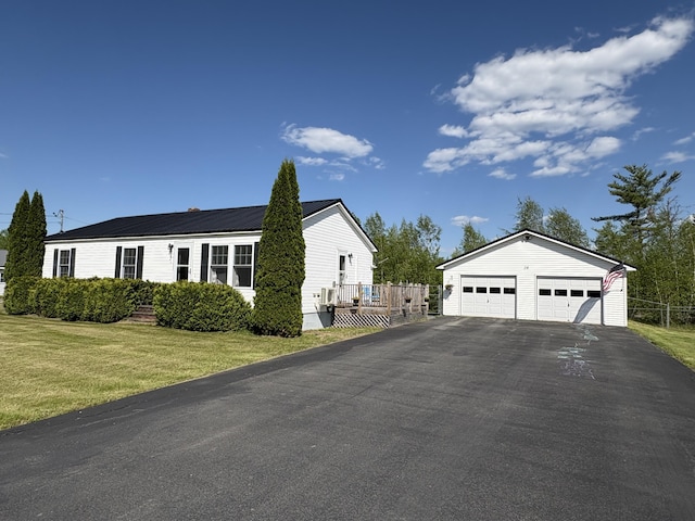16 Caron Dr, Howland, ME 04448 - view of property exterior featuring an outbuilding, a garage, and a lawn