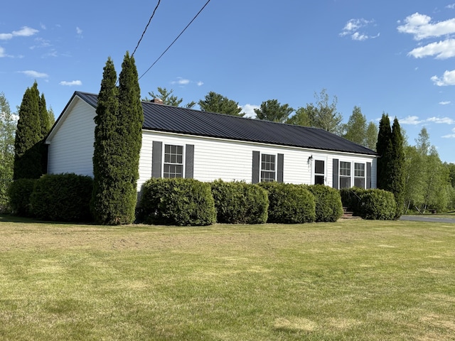 16 Caron Dr, Howland, ME 04448 - view of property exterior with a lawn and metal roof