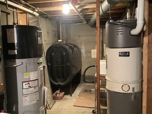 15 Blaine St, Fort Fairfield, ME 04742 - utility room with water heater, oil tank, and a central vacuum unit