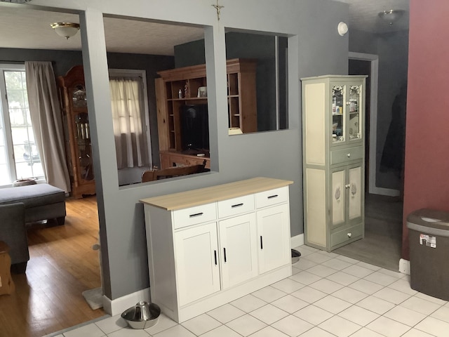 15 Blaine St, Fort Fairfield, ME 04742 - kitchen with light countertops, white cabinets, and light wood-style floors