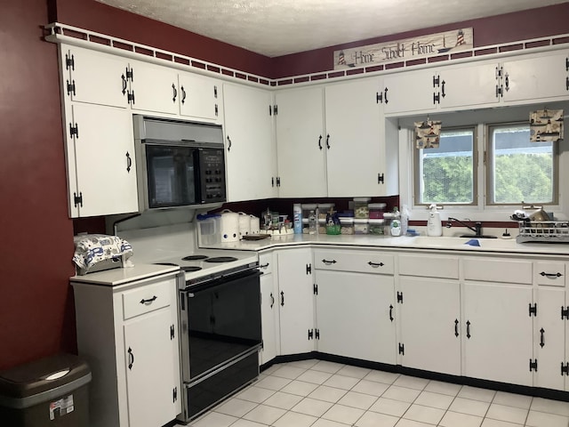 15 Blaine St, Fort Fairfield, ME 04742 - kitchen with electric stove, black microwave, a sink, light countertops, and white cabinets