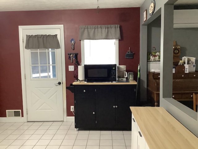 15 Blaine St, Fort Fairfield, ME 04742 - kitchen featuring black microwave, dark cabinetry, and light tile patterned floors