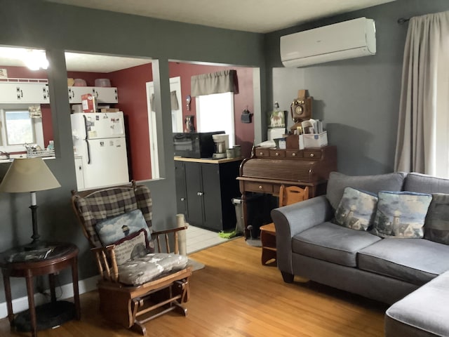 15 Blaine St, Fort Fairfield, ME 04742 - living area featuring a wall mounted AC and light wood-style floors