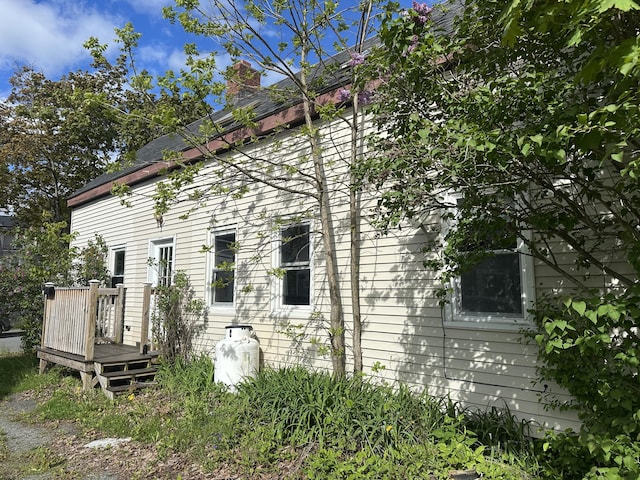 163 Court St, Bangor, ME 04401 - view of home's exterior featuring a deck and a chimney