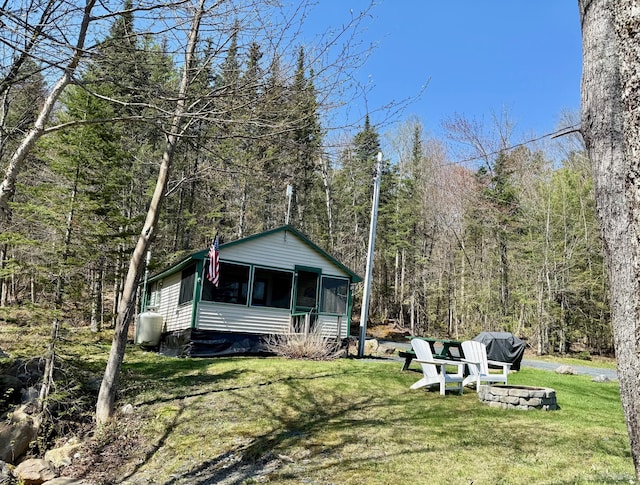 15 Wilson Pond Rd (Hedgehog), Unit Hedgehog Greenville, ME 04441 - view of front of house featuring a sunroom, a view of trees, and a front lawn