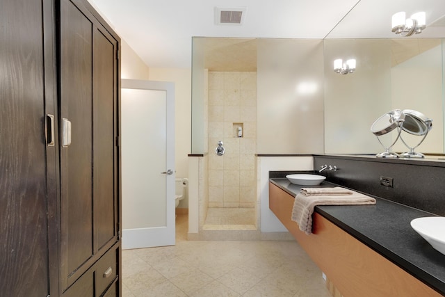 48 Federal St Unit B, Portland, ME 04101 - bathroom featuring double vanity, toilet, tiled shower, baseboards, and tile patterned floors