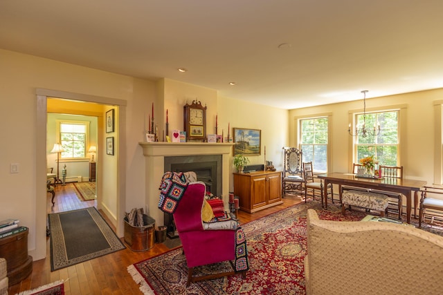 337 Washington St, Camden, ME 04843 - living room with hardwood / wood-style floors, a chandelier, a fireplace, recessed lighting, and baseboards